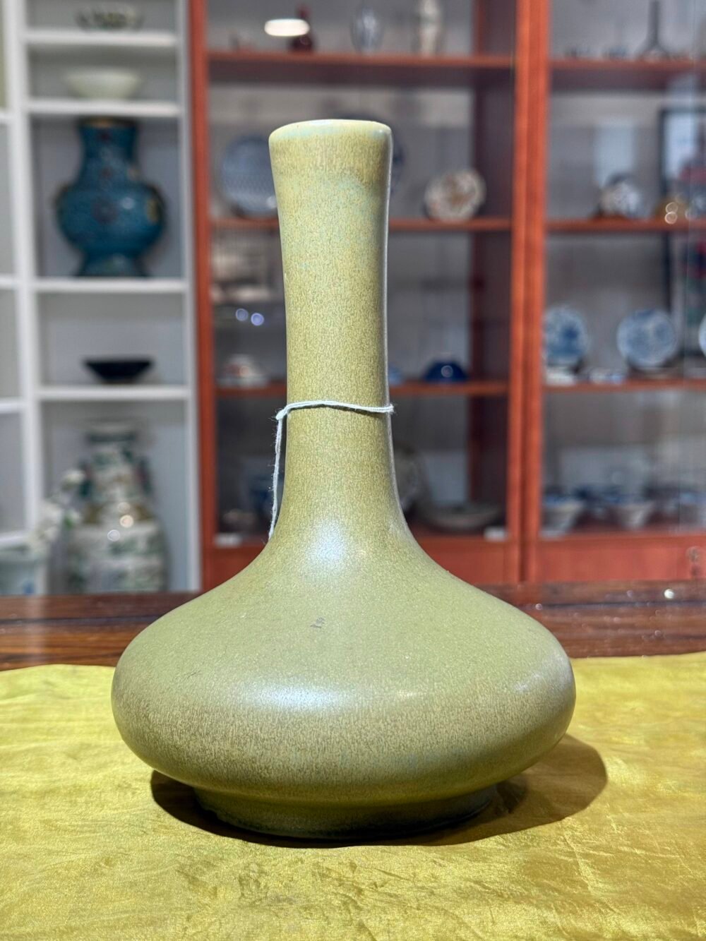 A green glaze vase with long neck